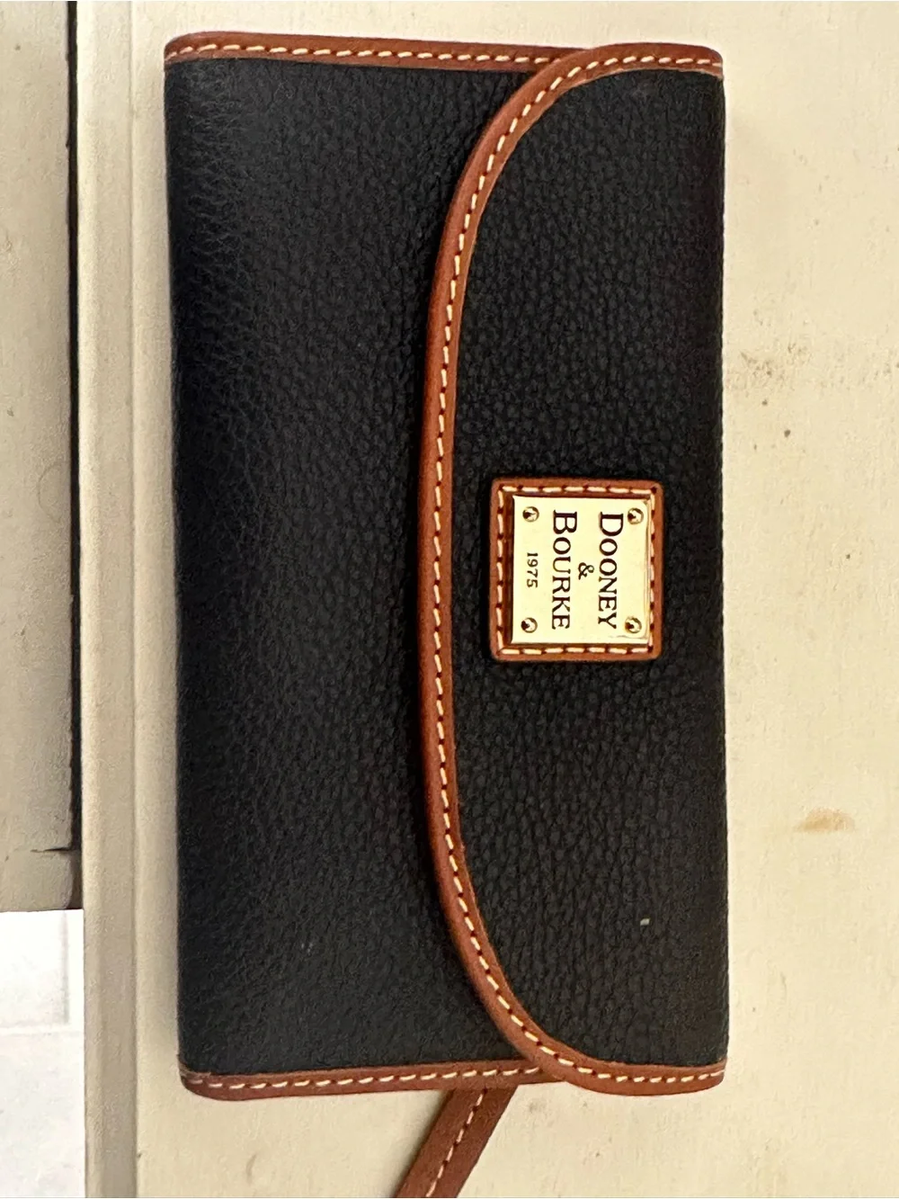 Dooney & Bourke Black Wallet with Brown Trim and Gold Plaque